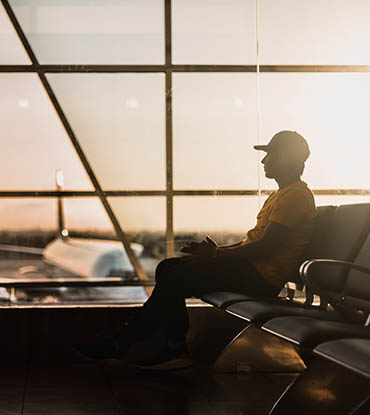 guy in an airport with a plane in background